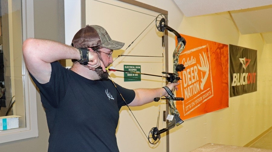 A man shooting a compound bow 