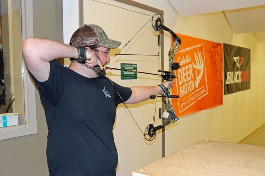 man shooting a bow 