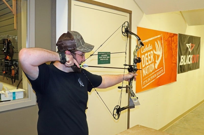 a man shooting the diamond prism compound bow