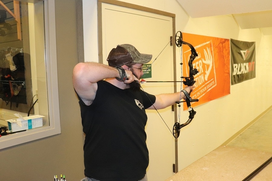 a man shooting a bow 