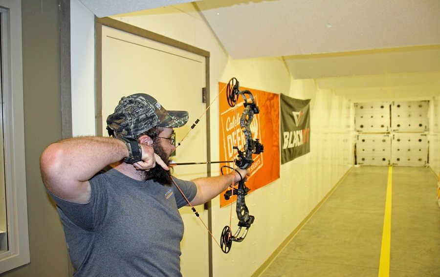 a man shooting a bow 