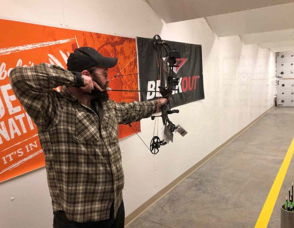 A Man shooting a Compound Bow