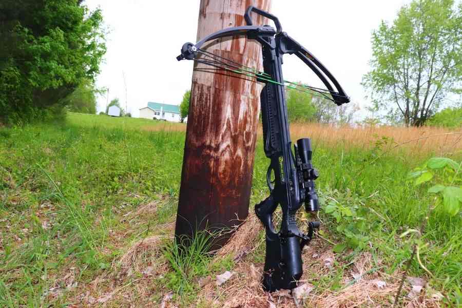 crossbow outside leaning at a pole