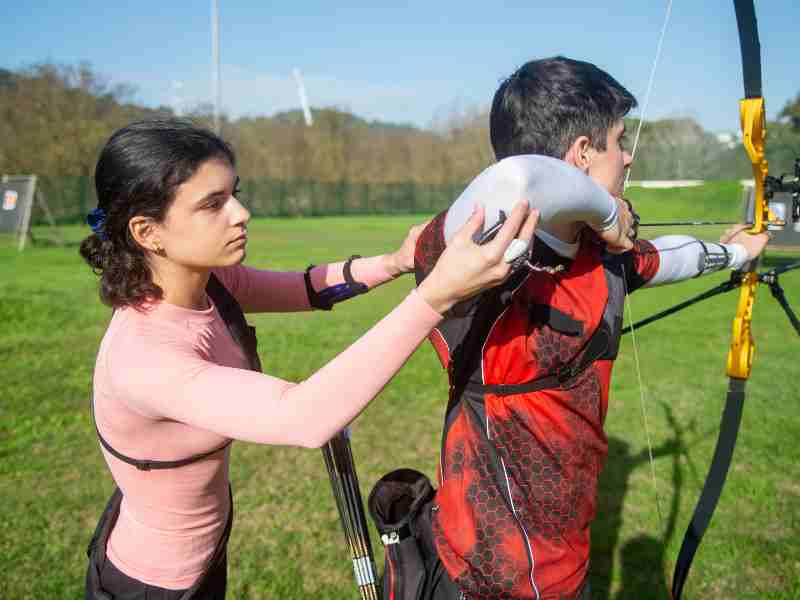 two people practicing on archery form finden the right posture and anchor point